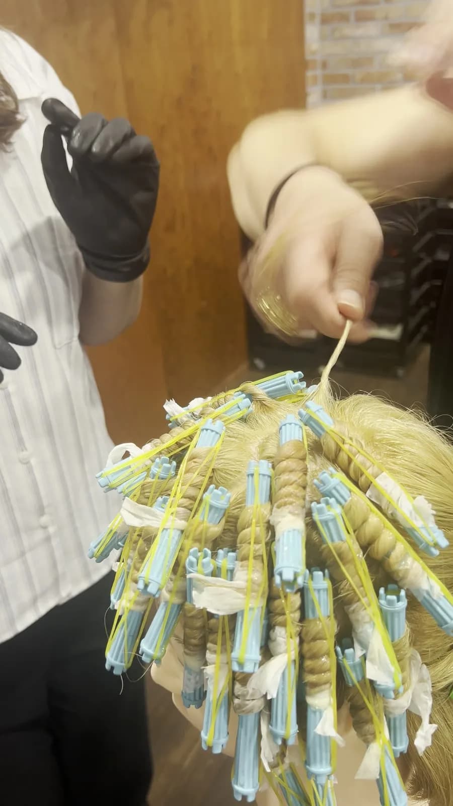 My hands on a strand with end paper, mannequin head