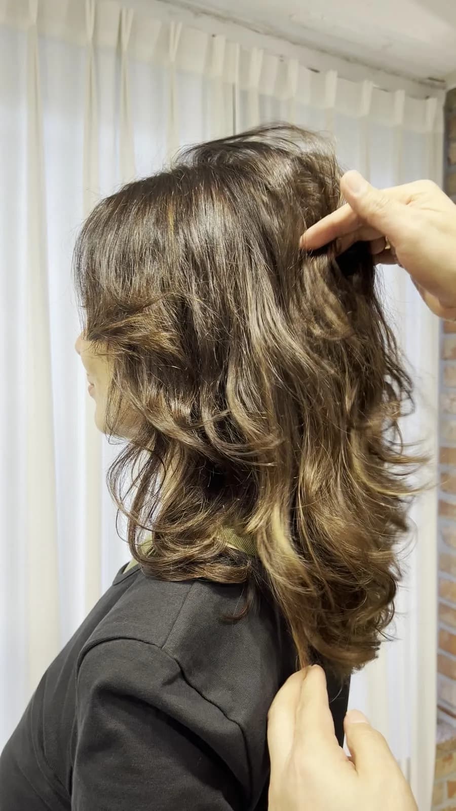 Soft shoulder-length waves after the August perm, side view